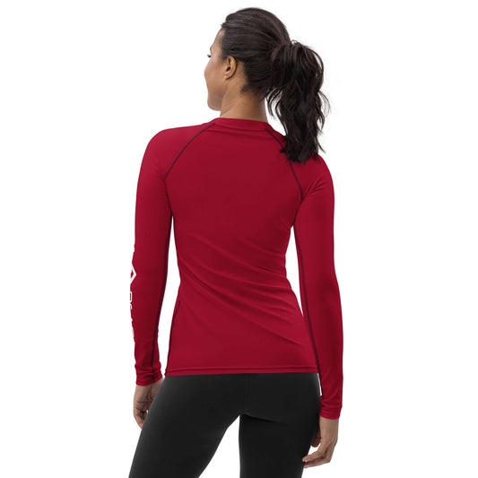Woman wearing a red Women's Rash Guard, showcasing the fitted design and long sleeves for outdoor activities.