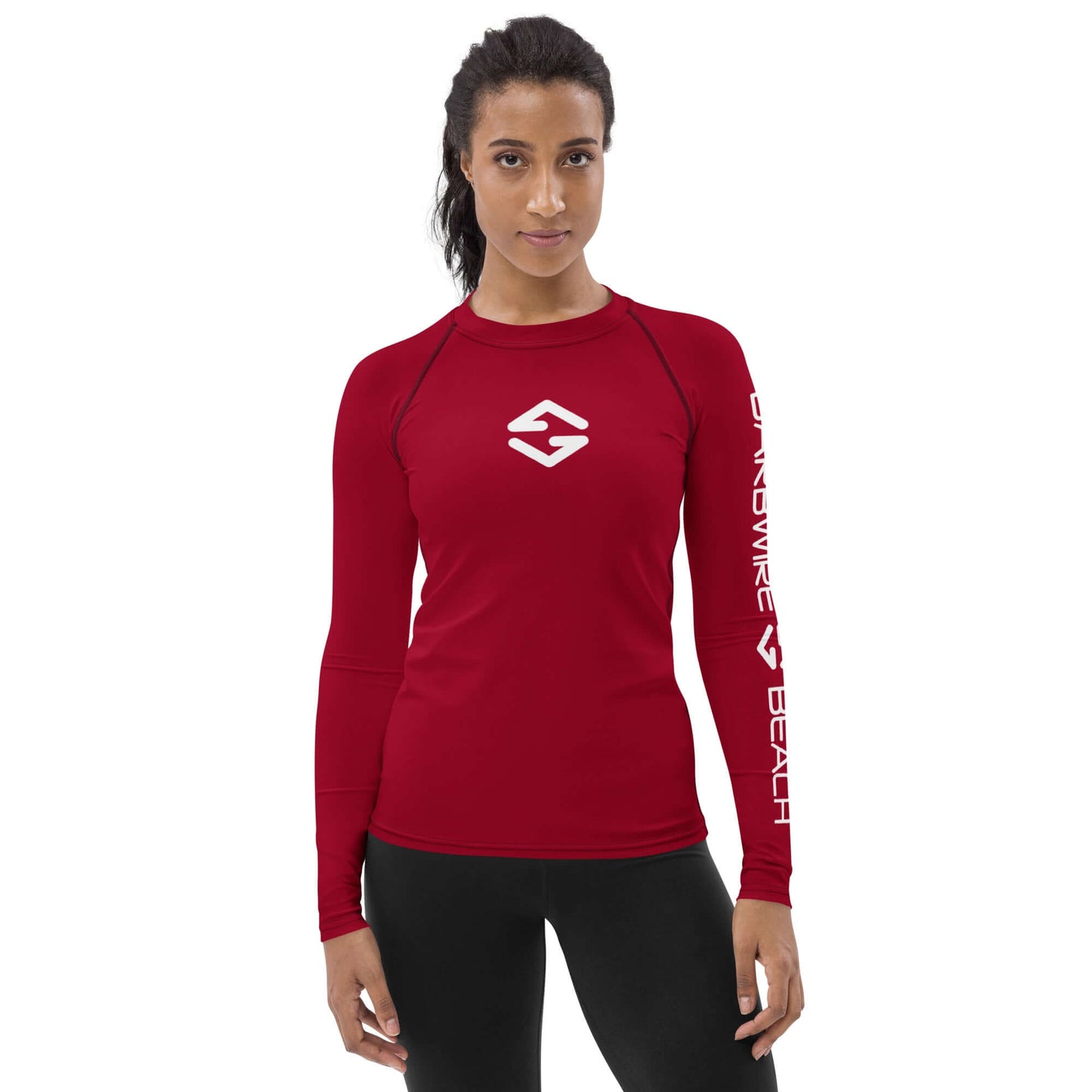 Athletic woman wearing a red Women's Rash Guard with long sleeves, designed for sun protection and active wear.