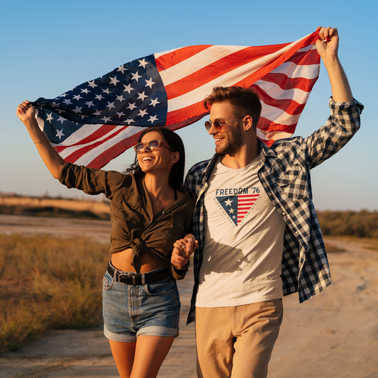 Couple holding an American flag outdoors with a scenic background