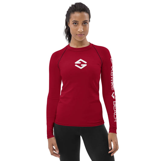 Athletic woman wearing a red Women's Rash Guard with long sleeves, designed for sun protection and active wear.