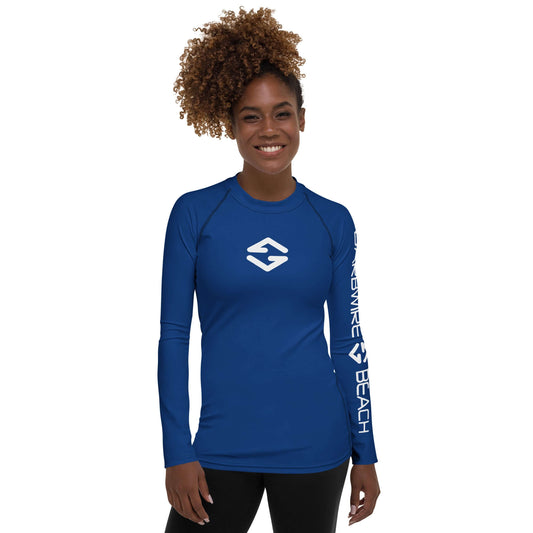 Model wearing Women's Rash Guard in Signature Blue with long sleeves and Barbwire Beach logo.