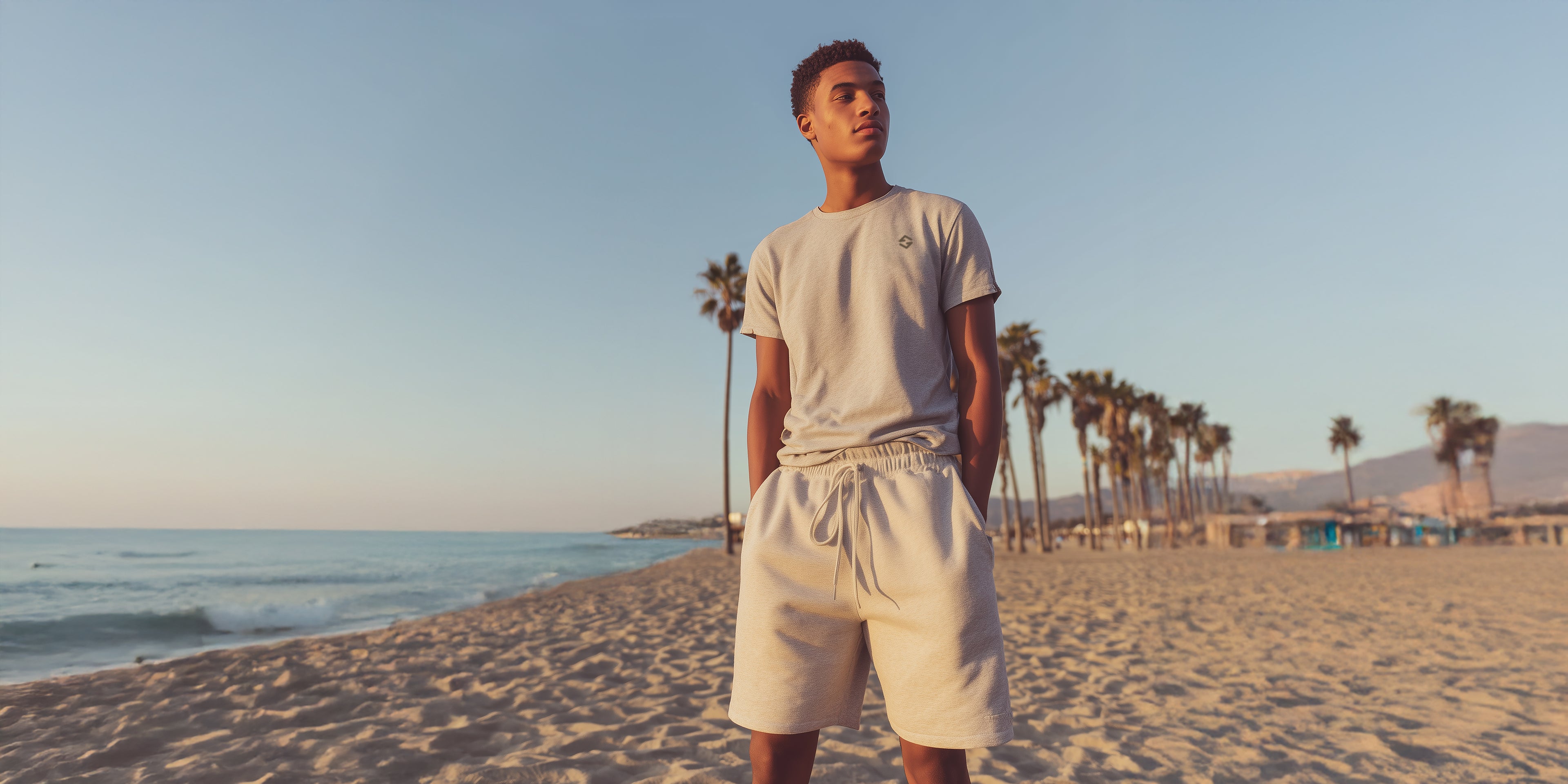 Person standing on a beach with palm trees and ocean in the background